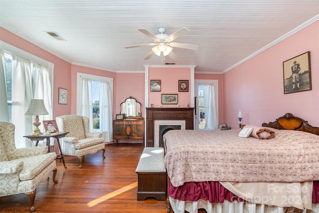 bedroom with dark hardwood / wood-style floors, multiple windows, crown molding, and ceiling fan