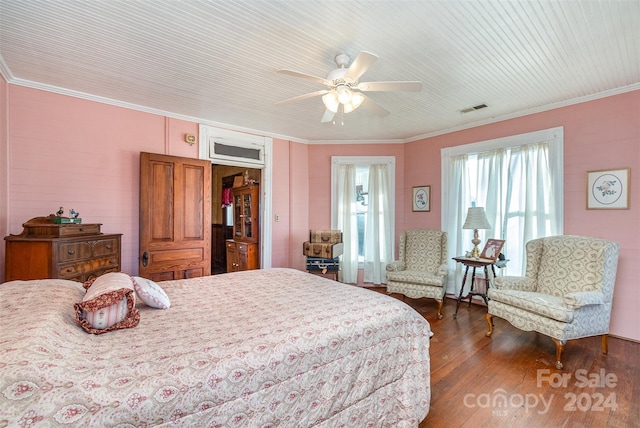 bedroom with ceiling fan, dark hardwood / wood-style flooring, and ornamental molding