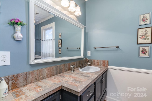 bathroom with vanity and crown molding