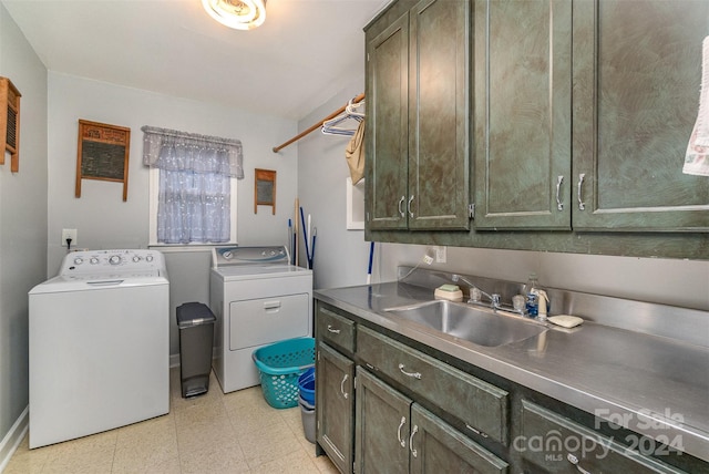 laundry area with cabinets, sink, and washing machine and dryer