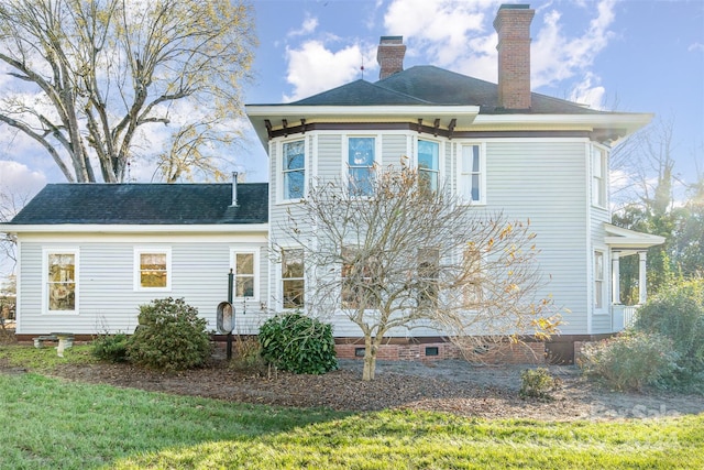 rear view of property featuring a yard