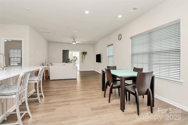 dining area featuring ceiling fan and light wood-type flooring