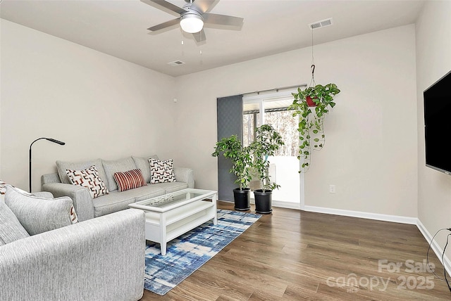 living room with wood-type flooring and ceiling fan