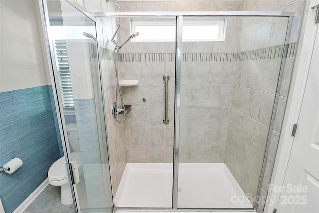 bathroom featuring toilet and walk in shower