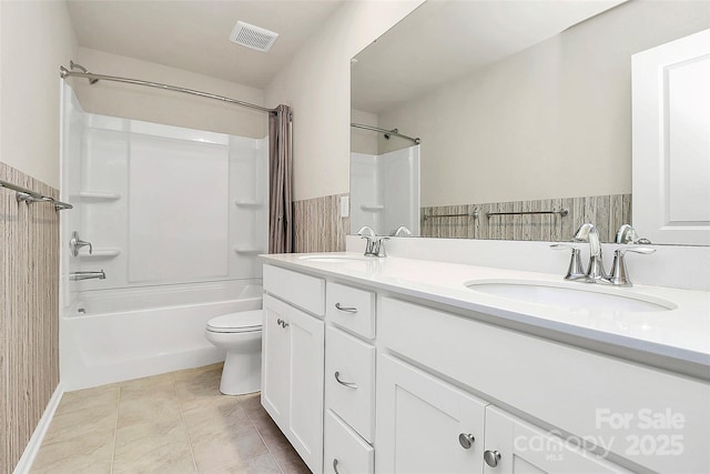 full bathroom featuring vanity, bathing tub / shower combination, and toilet