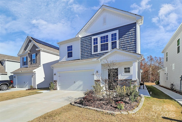 view of front of property featuring a garage and a front yard