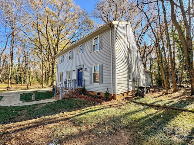 view of front facade with a front lawn and central AC unit