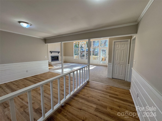 hallway featuring ornamental molding and hardwood / wood-style flooring