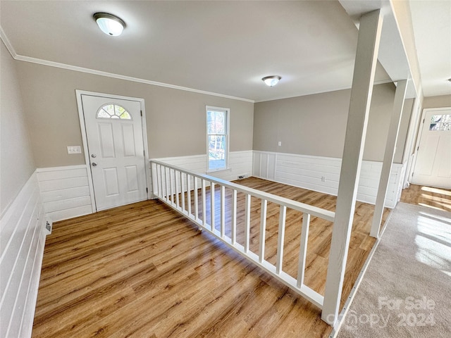 entryway featuring hardwood / wood-style floors and ornamental molding