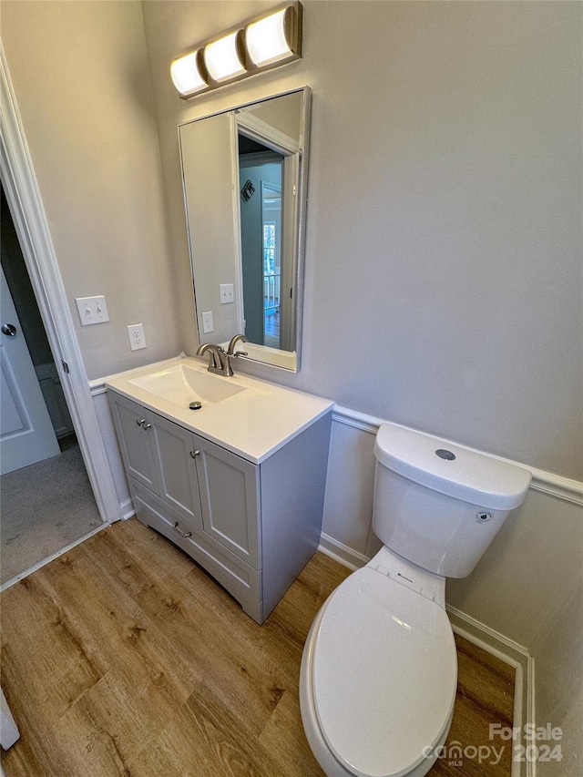 bathroom featuring hardwood / wood-style floors, vanity, and toilet