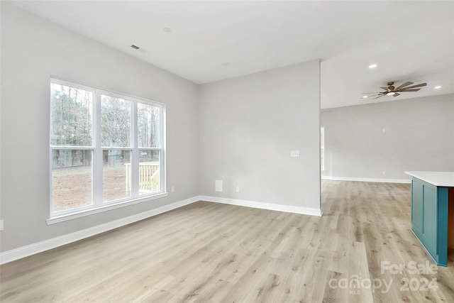 unfurnished room with light hardwood / wood-style flooring, a wealth of natural light, and ceiling fan