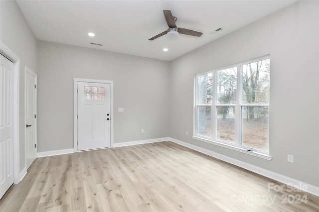 spare room with light hardwood / wood-style flooring and ceiling fan