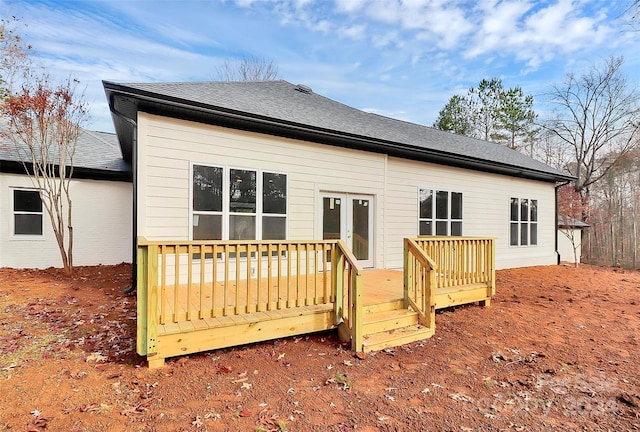 rear view of house featuring a deck and french doors