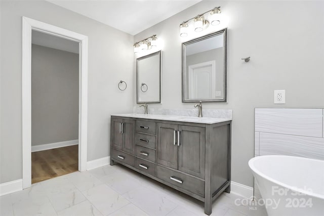 bathroom featuring vanity and a bath