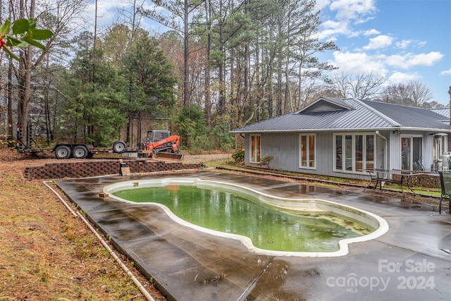 view of swimming pool with a patio area and french doors