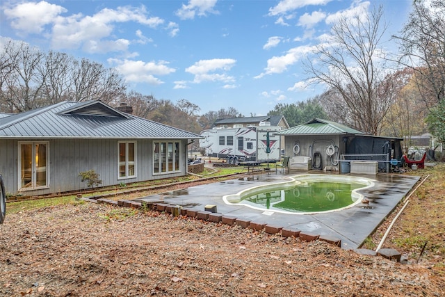 back of property featuring french doors and a patio