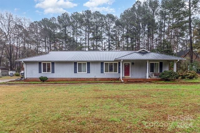 ranch-style home with covered porch and a front yard