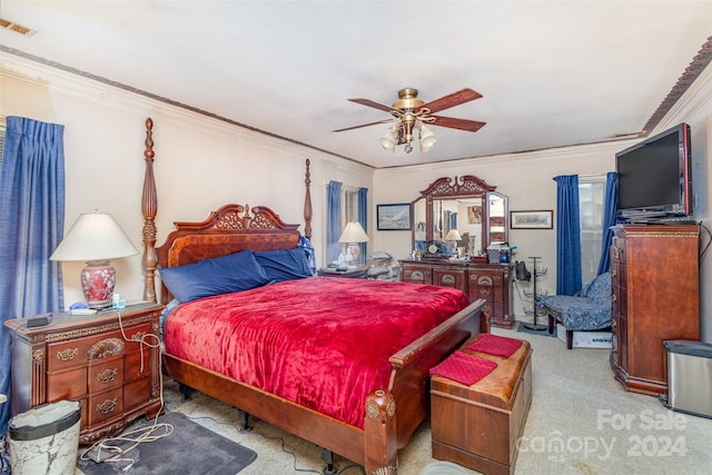 bedroom with ceiling fan, light colored carpet, and crown molding