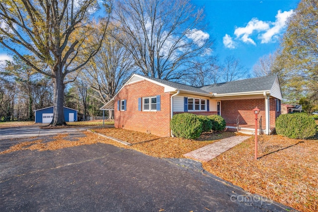 view of front of property with a garage and an outbuilding