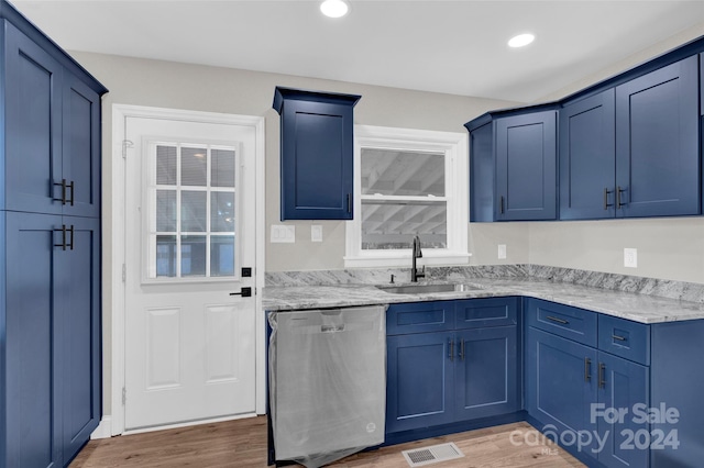 kitchen featuring light stone counters, dark wood-type flooring, sink, blue cabinetry, and dishwasher