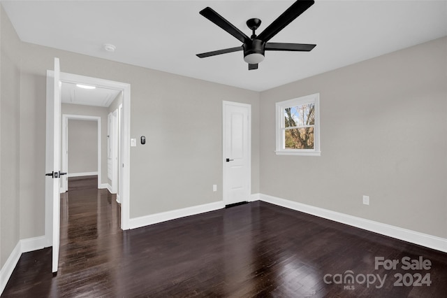 unfurnished bedroom featuring ceiling fan and dark wood-type flooring