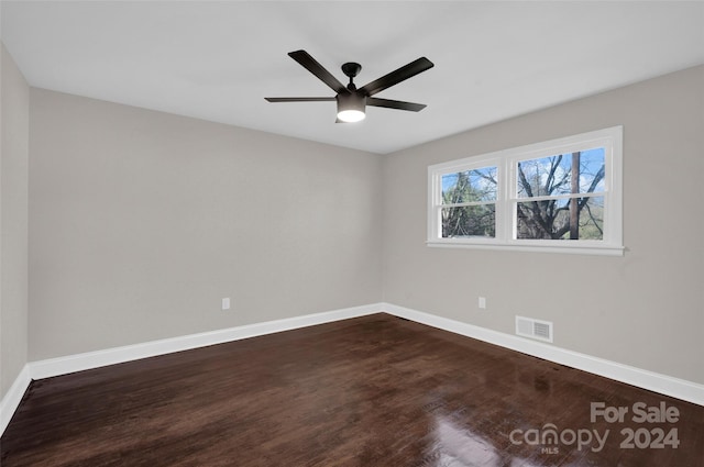 spare room with ceiling fan and dark hardwood / wood-style flooring