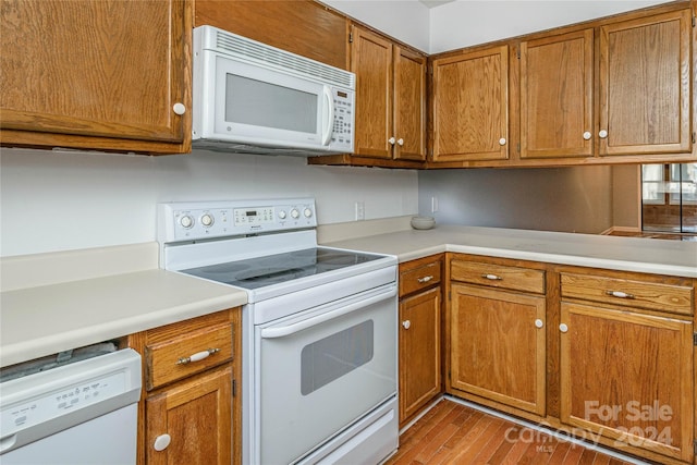 kitchen featuring white appliances and light wood-type flooring