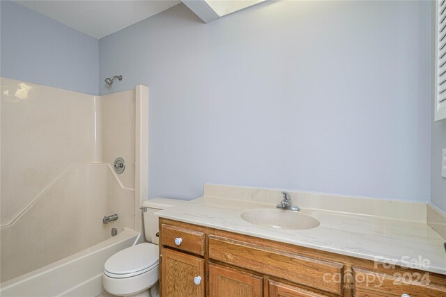 full bathroom with vanity, toilet, and  shower combination