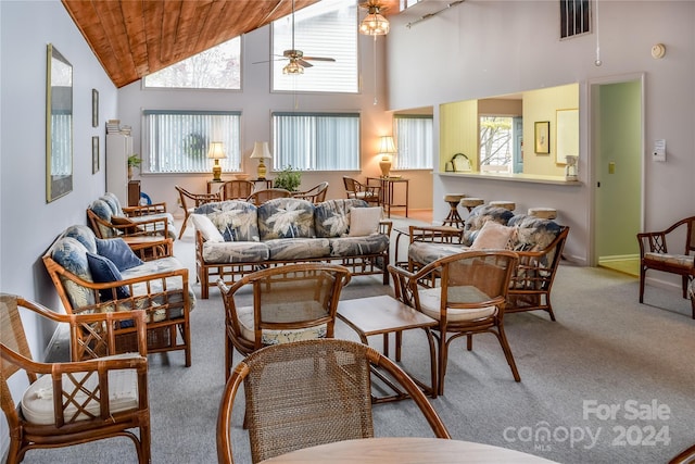 living room with wood ceiling, ceiling fan, high vaulted ceiling, and light colored carpet