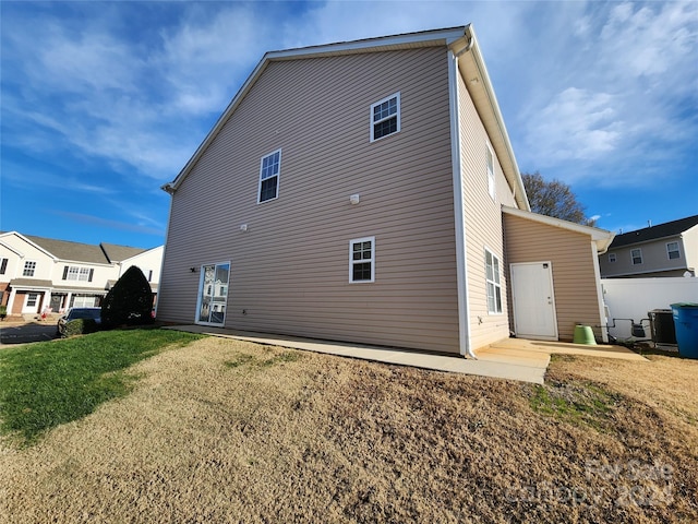 back of property featuring a lawn