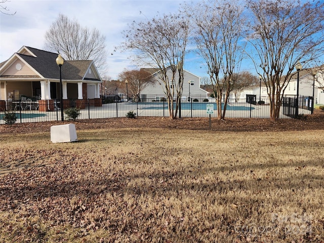 view of yard with a fenced in pool