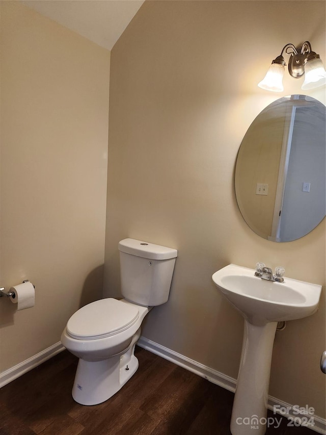 bathroom featuring hardwood / wood-style flooring and toilet