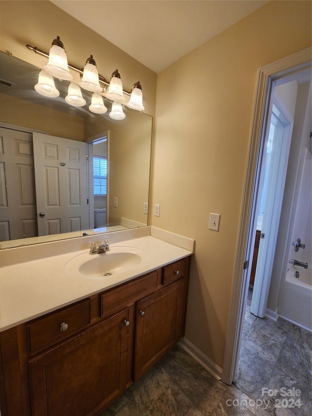 bathroom featuring vanity and a tub