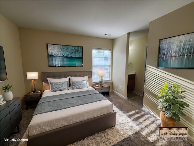 carpeted bedroom featuring connected bathroom