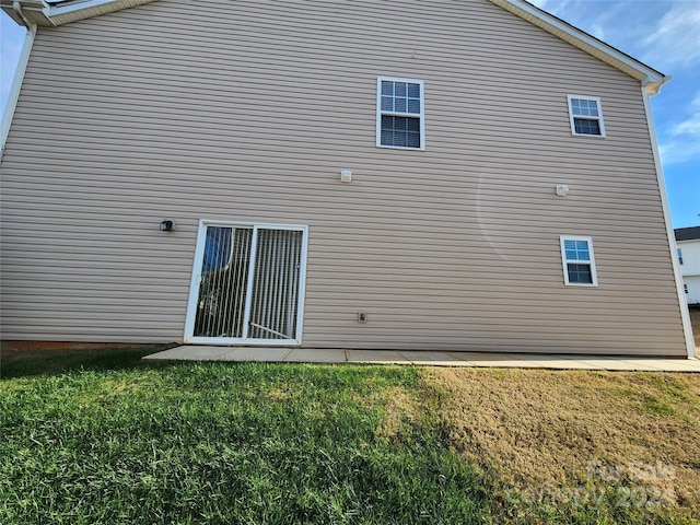 back of property featuring a lawn