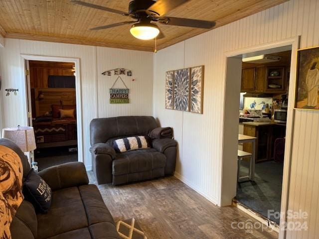 living room featuring ceiling fan, wooden ceiling, dark hardwood / wood-style floors, and ornamental molding