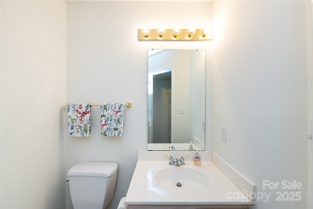 bathroom with toilet and vanity