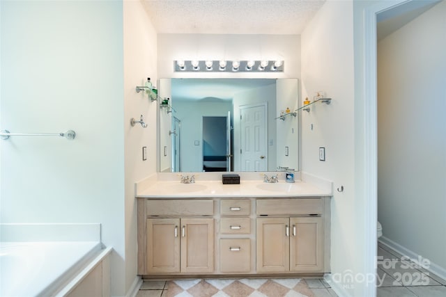 full bathroom with toilet, a garden tub, double vanity, and a sink