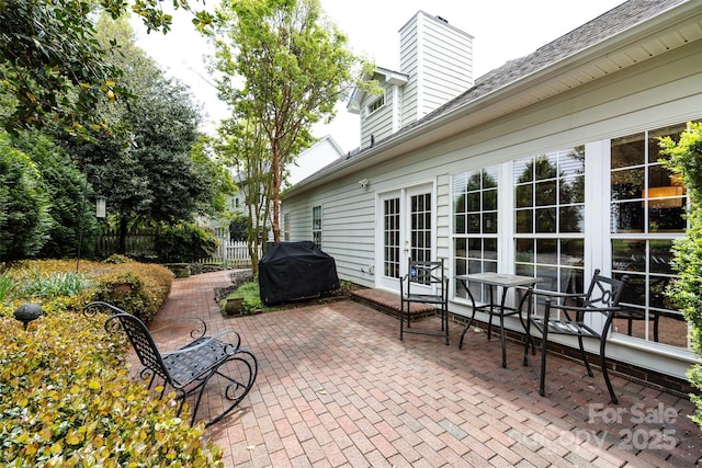 view of patio / terrace with french doors, fence, and area for grilling