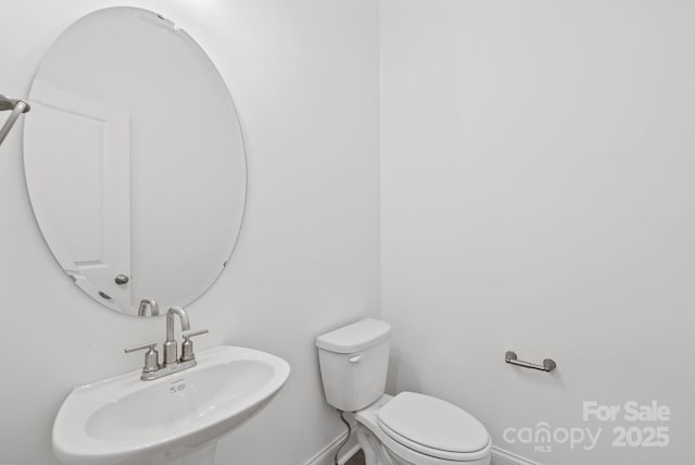 bathroom featuring sink and toilet