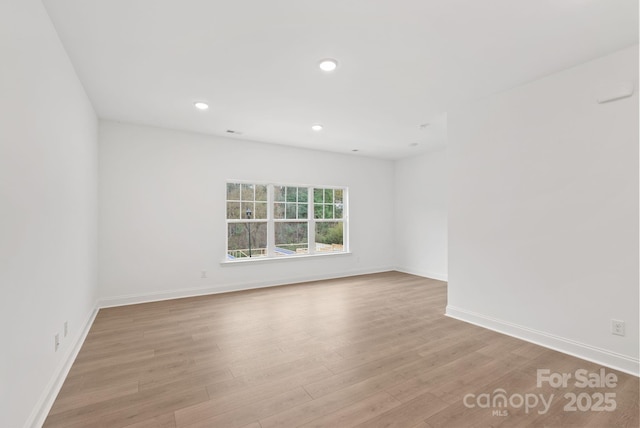 unfurnished room with light wood-type flooring