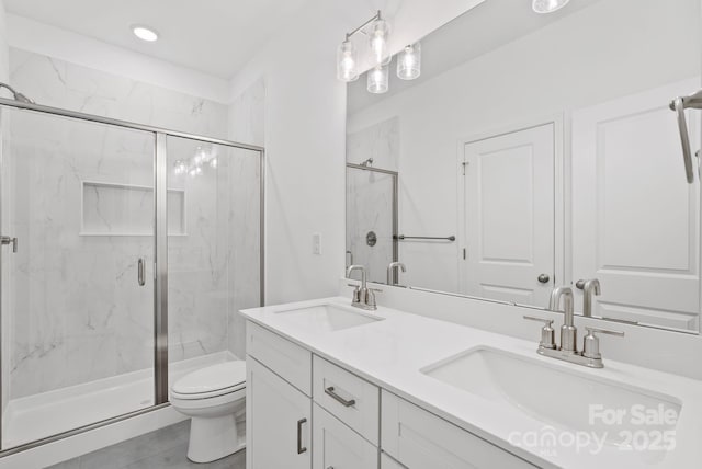 bathroom featuring walk in shower, vanity, and toilet