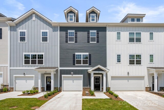 190 Cherry Springs Ln Unit 1-E, Asheville, NC 28804 - townhome / multi-family property featuring board and batten siding, an attached garage, stone siding, and driveway