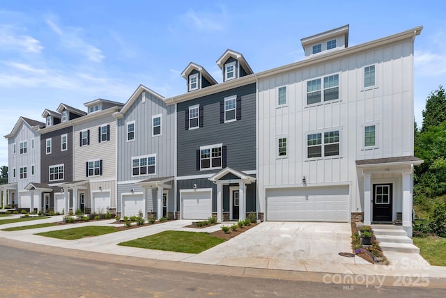 190 Cherry Springs Ln Unit 1-E, Asheville, NC 28804 - townhome / multi-family property with board and batten siding, driveway, a garage, and stone siding