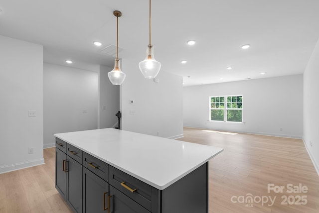 190 Cherry Springs Ln Unit 1-E, Asheville, NC 28804 - kitchen with light wood-type flooring, a center island, light countertops, decorative light fixtures, and recessed lighting