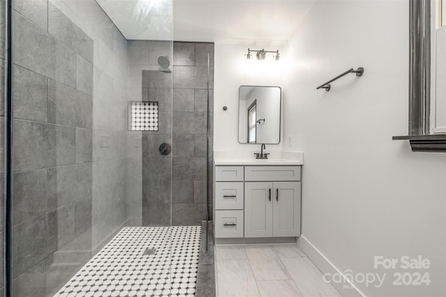 bathroom featuring a tile shower and vanity