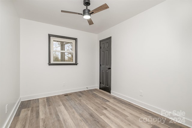 unfurnished room featuring ceiling fan and light wood-type flooring