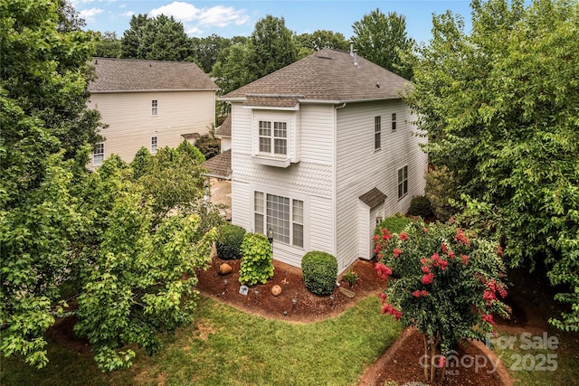 view of home's exterior with a yard