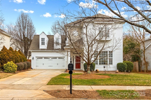 view of front of home with a garage and a front lawn