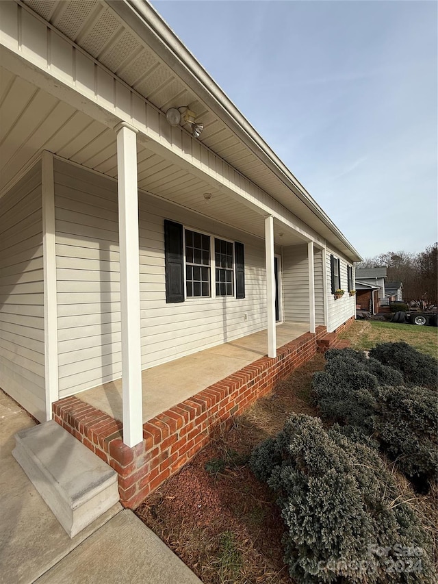 view of side of home with covered porch